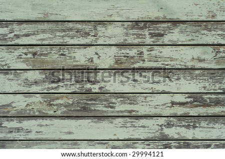 Fragment of old chipped blue painted wooden wall