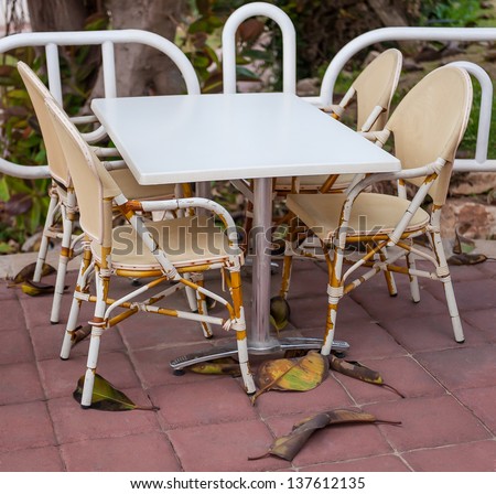 A lonely clean cafe table and four seats at a street restaurant in the Mediterranean