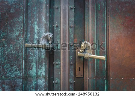 antique metal gate with horse shaped handles