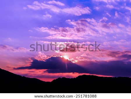 Purple sunset on mountains, dramatic sky, purple sunset