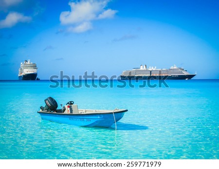 HALF MOON CAY, BAHAMAS - MARCH 7: Rescue boat and cruise ships floating in the beautiful sea water on March 7, 2015 on island Half Moon Cay of Bahamas.