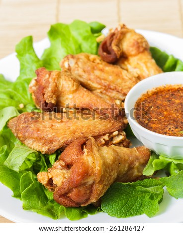 Deep fried chicken wings with chili hot sauce