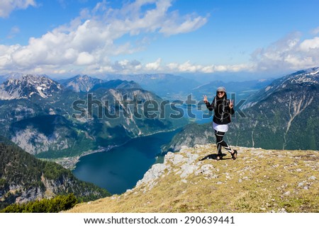 Happy Asian woman enjoying vacation with beautiful landscape of mountains and lake on summertime in Austria, Europe.