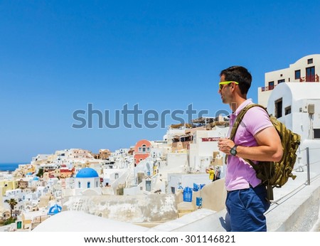 SANTORINI, GREECE- JUNE 16: Tourists visiting beautiful city of Oia on Santorini island in Greece on June 16, 2015. Santorini is one of the most popular tourist destinations in Greece.