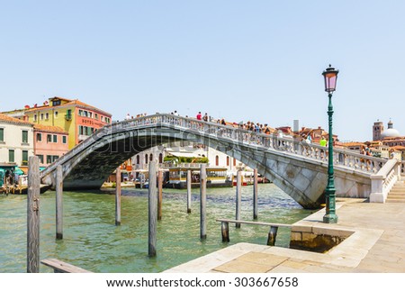 VENICE, ITALY- JULY 21: People crossing Grand canal on the bridge near by Train station Venezia Santa Lucia in Venice, Italy on July 21, 2015.