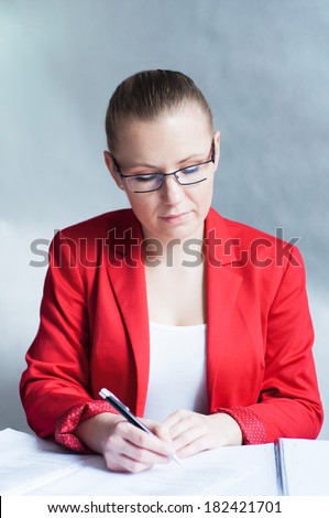 Young woman signing documents.