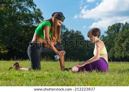 Sport injuries...Sports doctor giving first aid