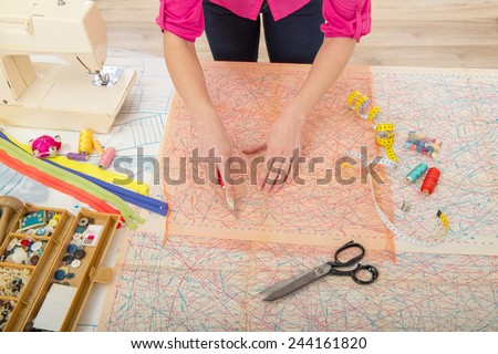 Woman sewing at home with sewing paper