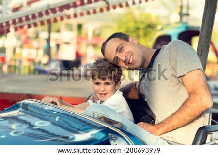 Son and father in the amusement park.