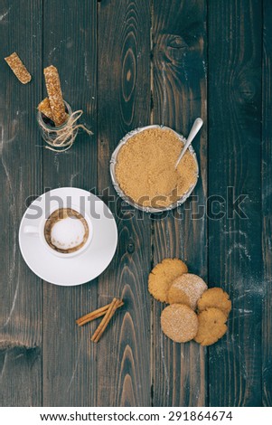 Cookies and coffee on the wooden table.