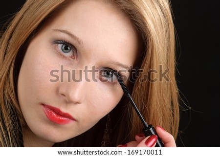 Young woman doing makeup