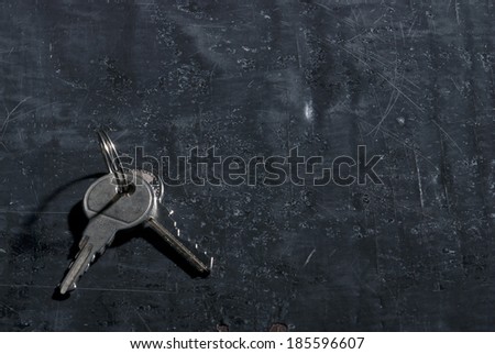 Keys on old black painted background