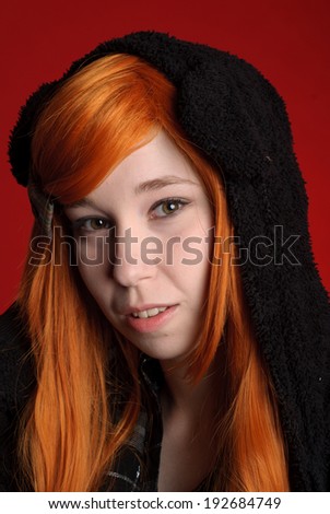 Beautiful young girl with red-orange hair in hood