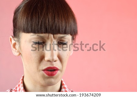 Pretty pin-up brunette woman in checkered shirt crying