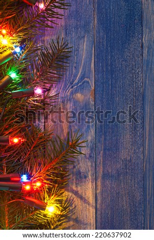 Christmas rustic background - vintage blue planked wood with lights and free text space