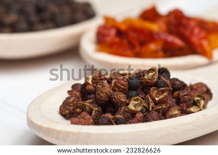 Spices. Sichuan pepper in wooden spoon - shallow depth of field