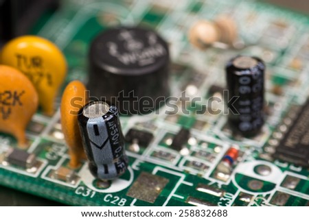 Close-up of electronic circuit board with chips and capacitors - shallow depth of field