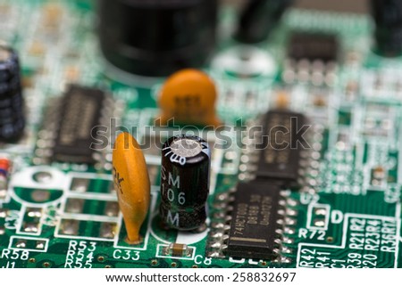 Close-up of electronic circuit board with chips and capacitors - shallow depth of field