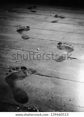 close up step forward on dusty floor monochrome