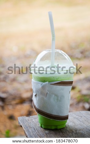Close up of milk green tea smoothie in plastic cup
