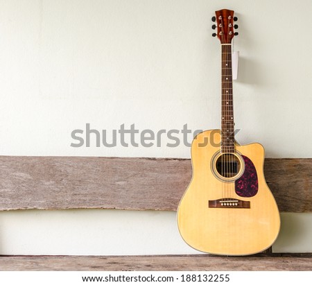 Acoustic guitar on old wall