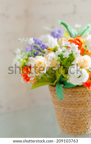 Artificial flowers bouquet in a natural pot