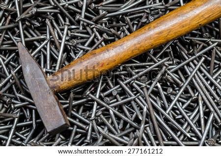 Pile of iron nails with hammer