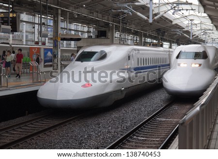 KYOTO, JAPAN - AUGUST 14: Two Shinkansen trains depart from rail station in Japan on August 14, 2012. Shinkansen is a comfortable and the fastest transportation to get to any remote area of Japan.