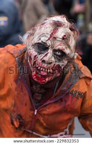 Paris, France - November 8, 2014: People dressed as a zombie parades on a street during a zombie walk in Paris.