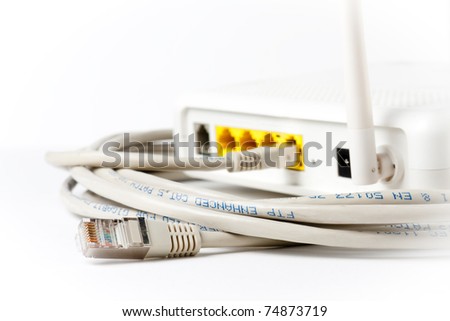 A router in top of an ethernet cable. Focus on the plug not connected.