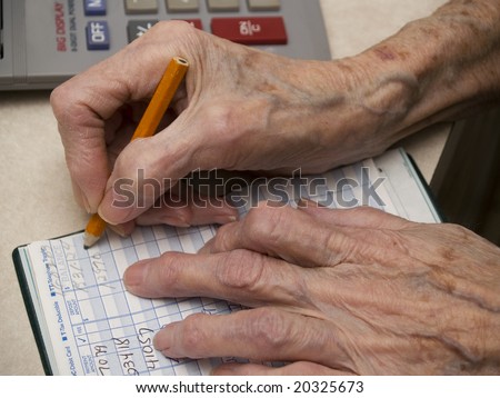 Senior counting money in the checkbook