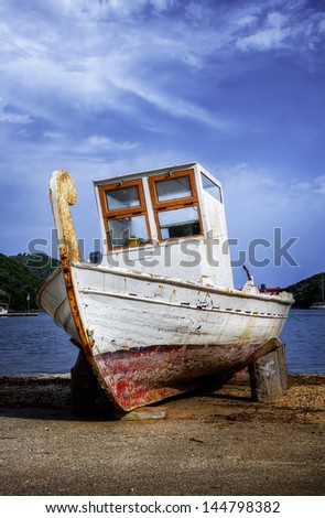 A small fishing boat out of the water, for repairs, in Syvota village, Lefkada island, Greece