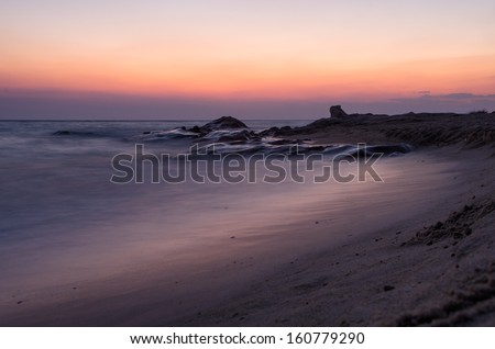 Dusk over a beach in Sithonia, Chalkidiki, Greece, with silky smooth water
