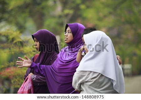 MALACCA, MALAYSIA - JUNE 22: Group of Muslim women on the street on June 22, 2013 in Malacca, Malaysia. Malacca is a historical city center has been listed as a UNESCO World Heritage Site.