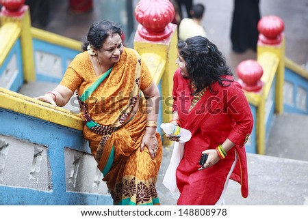 KUALA LUMPUR, MALAYSIA - JUNE 21: Two Indian women walking up to Batu Cave Temples on June 21, 2013 in Kuala Lumpur, Malaysia. The Batu caves is one of the most popular Hindu shrines outside India.