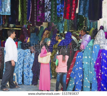 SANLIURFA, TURKEY - AUGUST 15: Unidentified muslims shopping for local fabric in the market on August 15, 2013 in Sanliurfa, Turkey.