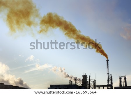 industrial factory with orange smoke