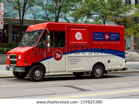 TORONTO, CANADA - OCTOBER 18, 2013: A Canadian Post van on a road in Toronto on  October 18th 2013