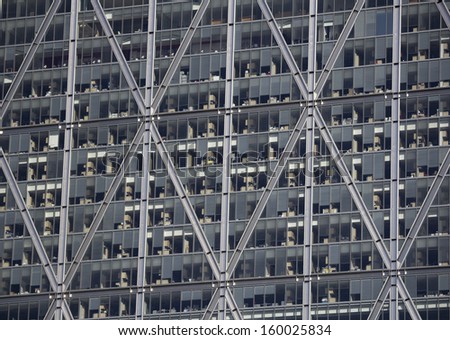 LONDON, UK - JUNE 2, 2013: The outside of a modern office building in London showing desks and lots of glass windows on June 2nd 2013