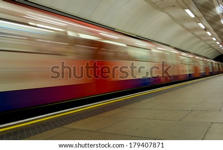 LONDON, UK - 22ND JUNE 2013: A moving train arriving at a London Underground station platform