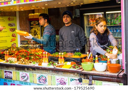 LONDON, UK - 1ST MARCH 2014: People serving food at Camden Food market