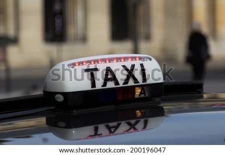 PARIS, FRANCE - 19TH MARCH 2014: Closeup to a Sign for a Taxi in Paris during the day