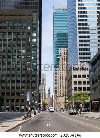TORONTO, CANADA - 28TH JUNE 2014: View up Bay Street during the day. The Old Town Hall Tower can be seen in the distance