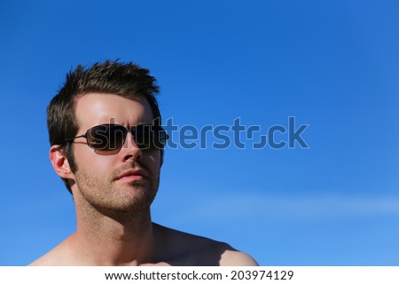 Male outside wearing sunglasses with copy space on the right