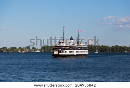 TORONTO, CANADA - 4TH JULY 2014: A ferry taking people to the Toronto Islands.