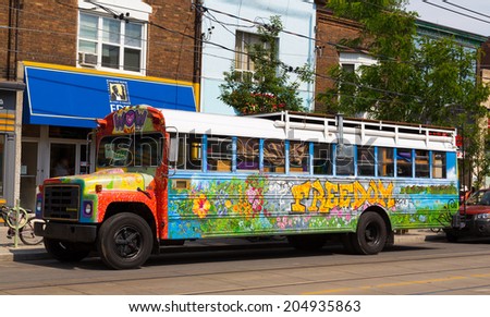 TORONTO, CANADA - 12TH JULY 2014: Colorful bus covered in paintings and images with the words Freedom written on the side