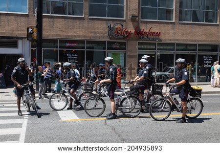 TORONTO, CANADA - 12TH JULY 2014: Group of Police Men in Downtown Toronto on push bikes.