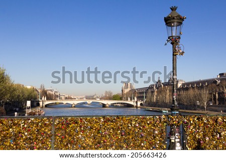 PARIS, FRANCE - 20TH MARCH 2014: Part of the Pont des Arts bridge with the the top of the Eiffel Tower showing in the background