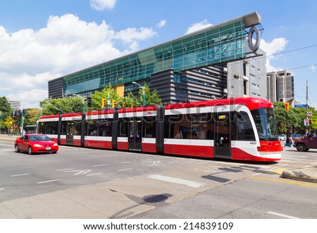 TORONTO, CANADA - 3RD SEPTEMBER 2014: A view of the new Toronto Street Cars during the day. Passengers can be seen on the vehicle