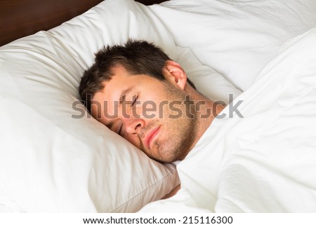 A sleeping man in bed